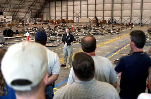 KENNEDY SPACE CENTER, FLA.  -  Astronaut Pam Melroy speaks to members of the Columbia Reconstruction Team during transfer of debris from the Columbia Debris Hangar to  its permanent storage site in the Vehicle Assembly Building.  More than 83,000  pieces of debris were shipped to KSC during search a