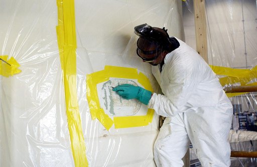 KENNEDY SPACE CENTER, FLA. - In the Solid Rocket Booster Assembly and Refurbishment Facility (ARF), Vernon Gibbs, with United Space Alliance, prepares the forward skirt of a solid rocket booster for installation of the parachute camera.  Refurbishment and subassembly of Shuttle SRB hardware - primar