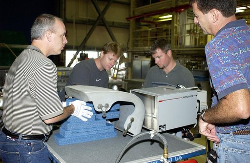 KENNEDY SPACE CENTER, FLA. - In the Orbiter Processing Facility, United Space Alliance workers share the task of examining  a Reinforced Carbon Carbon panel using flash thermography.  From left are Dan Kenna, Jim Landy, Paul Ogletree and Dan Phillips.  Attached to the leading edge of the wing of the