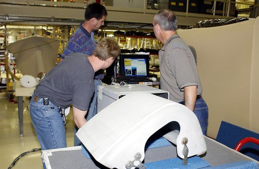 KENNEDY SPACE CENTER, FLA. - In the Orbiter Processing Facility, United Space Alliance workers Jim Landy (front), Dan Phillips and Dan Kenna watch a monitor showing results of flash thermography on the Reinforced Carbon Carbon panel on the table (foreground).  Attached to the leading edge of the win