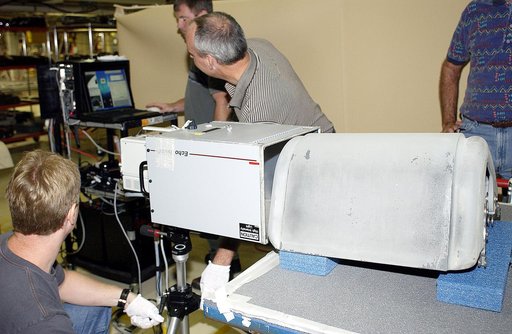 KENNEDY SPACE CENTER, FLA. - In the Orbiter Processing Facility, United Space Alliance workers (left to right) Jim Landy, Paul Ogletree, Dan Kenna and Dan Phillips check results of flash thermography on the Reinforced Carbon Carbon panel on the table (foreground).  Attached to the leading edge of th