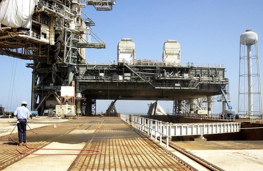 KENNEDY SPACE CENTER, FLA. - A worker sandblasts the surface behind the Mobile Launcher Platform on Launch Pad 39A .  Routine maintenance includes sandblasting and repainting as preventive means to minimize corrosion.