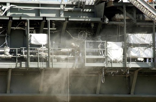 KENNEDY SPACE CENTER, FLA. - Workers, covered in protective clothing and breathing apparatus, continue sandblasting on the Mobile Launcher Platform on Launch Pad 39A to remove corrosion before repainting.  Routine maintenance includes sandblasting and repainting as preventive means to minimize corro