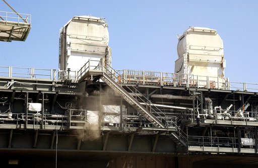 KENNEDY SPACE CENTER, FLA. -  On Launch Pad 39A, clouds of dust float away from the Mobile Launcher Platform, which is undergoing sandblasting to remove corrosion before repainting.  Routine maintenance includes sandblasting and repainting as preventive means to minimize corrosion.