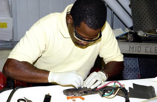 KENNEDY SPACE CENTER, FLA. -  United Space Alliance employee Anthony Simmons prepares to electroweld a crack formed in the insulator inside a Reinforced Carbon Carbon panel.   The gray carbon composite RCC panels are attached to the leading edge of the wing of the orbiters to withstand the aerodynam
