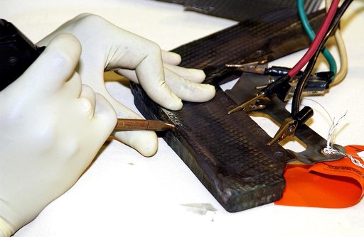 KENNEDY SPACE CENTER, FLA. -  United Space Alliance employee Anthony Simmons electrowelds a crack formed in the insulator inside a Reinforced Carbon Carbon panel.   The gray carbon composite RCC panels are attached to the leading edge of the wing of the orbiters to withstand the aerodynamic forces e