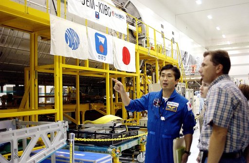 KENNEDY SPACE CENTER, FLA. - In the Space Station Processing Facility, Japanese astronaut Koichi Wakata looks over the Pressurized Module, or PM, part of the Japanese Experiment Module (JEM).  The PM provides a shirt-sleeve environment in which astronauts on the International Space Station can condu