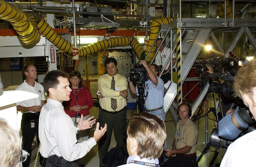 KENNEDY SPACE CENTER, FLA. -   NASA Vehicle Manager Scott Thurston (hands extended) talks to the media in the Orbiter Processing Facility.  The media was invited to see the orbiter Atlantis as it is being prepared for Return to Flight.  Both local and national reporters representing print and TV net
