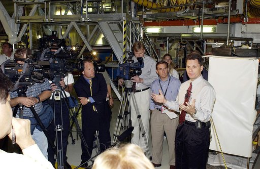 KENNEDY SPACE CENTER, FLA. -   NASA Vehicle Manager Scott Thurston (right)  talks to the media in the Orbiter Processing Facility .  The media was invited to see the orbiter Atlantis as it is being prepared for Return to Flight.  Both local and national reporters representing print and TV networks w
