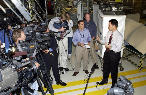 KENNEDY SPACE CENTER, FLA. -   NASA Vehicle Manager Scott Thurston (right)  talks to the media in the Orbiter Processing Facility.  The media was invited to see the orbiter Atlantis as it is being prepared for Return to Flight.  Both local and national reporters representing print and TV networks we