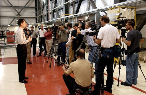 KENNEDY SPACE CENTER, FLA. - NASA Vehicle Manager Scott Thurston (left) talks to a phalanx of media in the Orbiter Processing Facility.  The media was invited to see the orbiter Atlantis as it is being prepared for Return to Flight.  Both local and national reporters representing print and TV networ