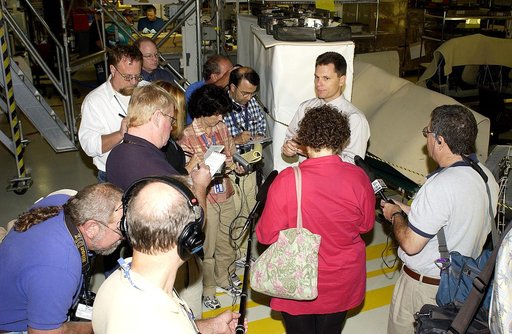 KENNEDY SPACE CENTER, FLA. -  NASA Vehicle Manager Scott Thurston (facing camera) talks to the media in the Orbiter Processing Facility.  The media was invited to see the orbiter Atlantis as it is being prepared for Return to Flight.  Both local and national reporters representing print and TV netwo