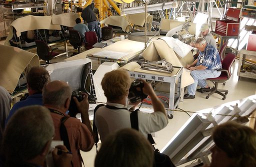 KENNEDY SPACE CENTER, FLA. -  In the Orbiter Processing Facility, the media record workers on the job preparing the orbiter Atlantis for Return to Flight. Both local and national reporters representing print and TV networks were invited to see work in progress on Atlantis, including the reinstallati