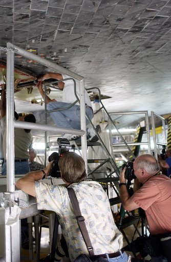 KENNEDY SPACE CENTER, FLA. -   In the Orbiter Processing Facility,  the media photograph work being done on the tiles on the orbiter Atlantis as it is being prepared for Return to Flight in the Orbiter Processing Facility.   Both local and national reporters representing print and TV networks were a