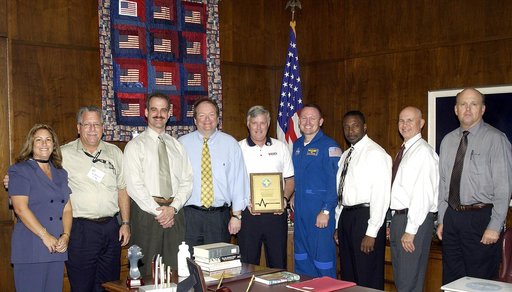 KENNEDY SPACE CENTER, FLA. -  Center Director Jim Kennedy (center) shares the kudos for Spaceport Super Safety and Health Day with members of the coordinating committee.  Astronaut Barry E. Wilmore (at right) presented the award to Kennedy.  Next to Wilmore at right is Dr. Woodrow Whitlow, KSC’s dep