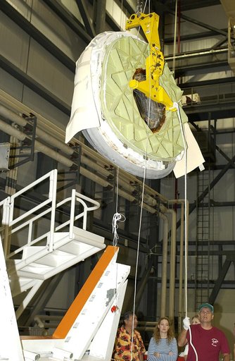 KENNEDY SPACE CENTER, FLA. - In the Orbiter Processing Facility, the nose cap of the orbiter Atlantis is lifted for its transfer to a stand.  The cap was removed for routine inspection. The nose cap is made of reinforced carbon-carbon (RCC), which has an operating range of minus 250° F to about 3,00