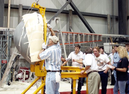 KENNEDY SPACE CENTER, FLA. -  In the Orbiter Processing Facility, workers secure the nose cap of the orbiter Atlantis on a stand.   The cap was removed from the orbiter for routine inspection. The nose cap is made of reinforced carbon-carbon (RCC), which has an operating range of minus 250° F to abo