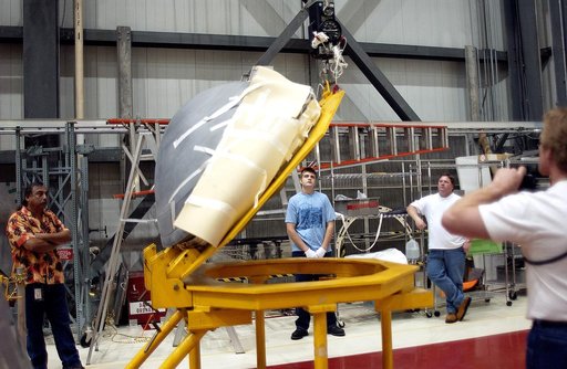 KENNEDY SPACE CENTER, FLA. - In the Orbiter Processing Facility, the nose cap of the orbiter Atlantis is shifted to a horizontal position on a stand.  The cap was removed from the orbiter for routine inspection. The nose cap is made of reinforced carbon-carbon (RCC), which has an operating range of 
