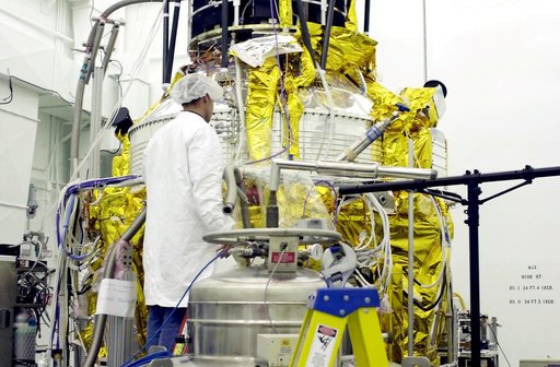 VANDENBERG AFB, CALIF. -   A worker in the spacecraft processing facility on North Vandenberg Air Force Base checks the Gravity Probe B experiment during prelaunch testing.  The Gravity Probe B will launch a payload of four gyroscopes into low-Earth polar orbit to test two extraordinary predictions 