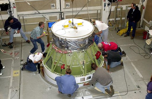 VANDENBERG AFB, CALIF. - Workers on the mobile service tower at Space Launch Complex 2, Vandenberg Air Force Base, Calif., check the Delta II rocket’s second stage as it is mated with the first stage. The Delta II is the launch vehicle for the Gravity Probe B experiment, developed by Stanford Univer