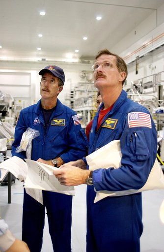 KENNEDY SPACE CENTER, FLA. - In the Space Station Processing Facility, STS-117 Mission Specialist James Reilly (left) and STS-115 Mission Specialist Joseph Tanner (right) look over the Japanese Experiment Module (JEM).  Equipment familiarization is a routine part of astronaut training and launch pre