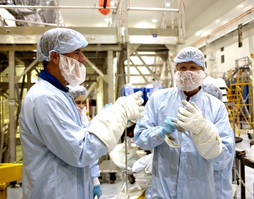 KENNEDY SPACE CENTER, FLA. -  STS-117 Mission Specialist James Reilly (left) and STS-115 Mission Specialist Joseph Tanner (right) put on protective gloves before their checkout of the Japanese Experiment Module (JEM) in the Space Station Processing Facility.  Reilly and Tanner are at KSC for equipme