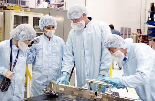 KENNEDY SPACE CENTER, FLA. - STS-115 Mission Specialist Joseph Tanner (second from right) checks out a camera and cables for the Japanese Experiment Module (JEM) in the Space Station Processing Facility. Known as Kibo, the JEM consists of six components: two research facilities - the Pressurized Mod