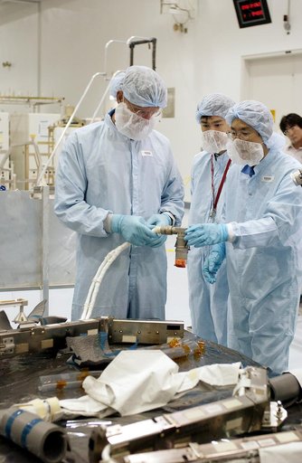 KENNEDY SPACE CENTER, FLA. -  In the Space Station Processing Facility, STS-115 Mission Specialist Joseph Tanner (left)  checks out a camera and cables to be used in the Japanese Experiment Module (JEM). Known as Kibo, the JEM consists of six components: two research facilities - the Pressurized Mod
