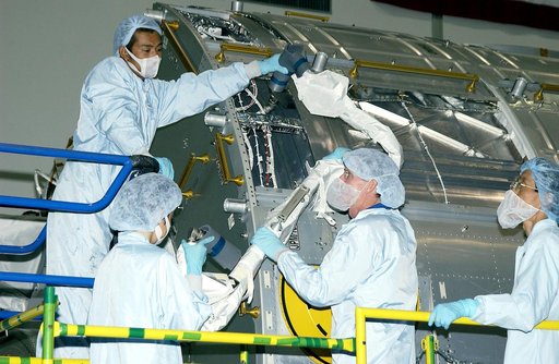 KENNEDY SPACE CENTER, FLA. -  In the Space Station Processing Facility, STS-115 Mission Specialist Joseph Tanner (center, foreground) works with technicians to learn more about the Japanese Experiment Module (JEM), known as Kibo.  The JEM consists of six components: two research facilities - the Pre