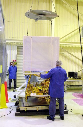 VANDENBERG AIR FORCE BASE, CALIF.- The cover is being lifted off SciSat-1 spacecraft at Vandenberg Air Force Base, Calif.   Sci-Sat, which will undergo instrument checkout and spacecraft functional testing, weighs approximately 330 pounds and after launch will be placed in a 400-mile-high polar orbi