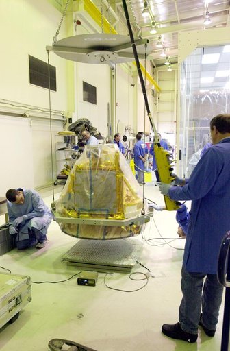 VANDENBERG AIR FORCE BASE, CALIF.-  The covered SciSat-1 spacecraft is lowered onto a test stand at Vandenberg Air Force Base, Calif., for functional testing.  The solar arrays will be attached and the communications systems checked out.   The SciSat-1 weighs approximately 330 pounds and after launc