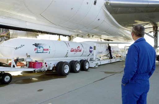 VANDENBERG AIR FORCE BASE, CALIF. - The Pegasus transporter, with its cargo of  the SciSat-1 payload and Pegasus launch vehicle, moves under the L-1011 carrier aircraft for matting.  The SciSat-1 weighs approximately 330 pounds and after launch will be placed in a 400-mile-high polar orbit to invest