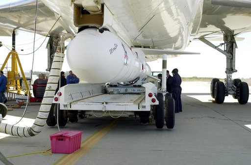 VANDENBERG AIR FORCE BASE, CALIF. -  The SciSat-1 payload and Pegasus launch vehicle are lifted and mated to the L-1011 carrier aircraft.  The SciSat-1 weighs approximately 330 pounds and after launch will be placed in a 400-mile-high polar orbit to investigate processes that control the distributio