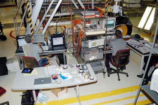 KENNEDY SPACE CENTER, FLA. -  In the Orbiter Processing Facility, Eric Madaras (left), NASA-Langley Research Center, and Jim McGee, The Boeing Company, Huntington Beach, Calif., conduct impulse tests on the right wing leading edge (WLE) of Space Shuttle Endeavour. The tests monitor how sound impulse