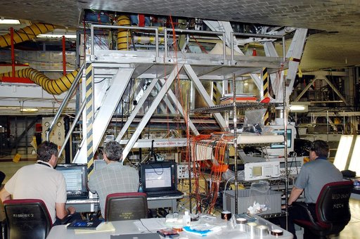 KENNEDY SPACE CENTER, FLA. -  In the Orbiter Processing Facility, Bill Prosser (left) and Eric Madaras, NASA-Langley Research Center, and Jim McGee (right), The Boeing Company, Huntington Beach, Calif., conduct impulse tests on the right wing leading edge (WLE) of Space Shuttle Endeavour. The tests 