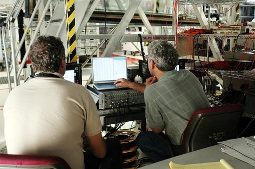KENNEDY SPACE CENTER, FLA. -  In the Orbiter Processing Facility, Bill Prosser (left) and Eric Madaras, NASA-Langley Research Center, conduct impulse tests on the right wing leading edge (WLE) of Space Shuttle Endeavour. The tests monitor how sound impulses propagate through the WLE area.  The data 