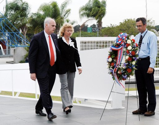 KENNEDY SPACE CENTER, FLA. -  NASA's Associate Administrator for Space Flight William Readdy (left) and Evelyn Husband, widow of astronaut Rick Husband, place a ceremonial wreath at the Space Mirror Memorial at the Kennedy Space Center Visitor Complex.  During this dedication ceremony, the names of 