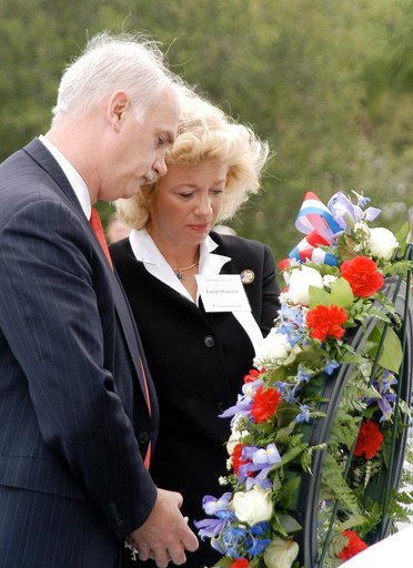 KENNEDY SPACE CENTER, FLA. -  NASA's Associate Administrator for Space Flight William Readdy and Evelyn Husband, widow of astronaut Rick Husband, place a ceremonial wreath at the Space Mirror Memorial at the Kennedy Space Center Visitor Complex.  During this dedication ceremony, the names of the STS