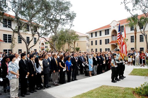 KENNEDY SPACE CENTER, FLA. -  Family members of the STS-107 astronauts and other dignitaries attending the Columbia Village dedication ceremony at the Florida Institute of Technology in Melbourne, Fla., stand for the posting of the colors by members of the university's ROTC.  Each of the seven new r