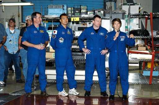 KENNEDY SPACE CENTER, FLA. - (From left) STS-114 Mission Specialists Stephen Robinson and Soichi Noguchi, Pilot James Kelly and Commander Eileen Collins talk to workers in the Orbiter Processing Facility. Noguchi is with the Japan Aerospace Exploration Agency, JAXA. The STS-114 crew is at KSC to tak