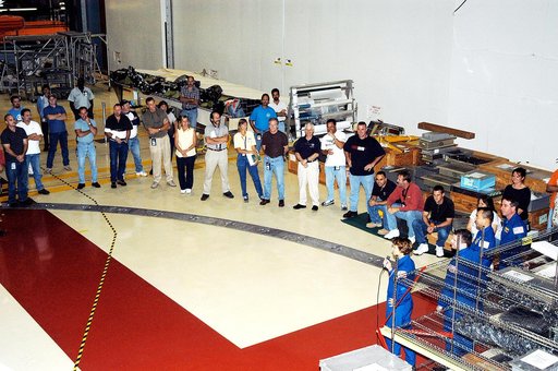 KENNEDY SPACE CENTER, FLA. - At right, STS-114 Commander Eileen Collins, Pilot James Kelly, and Mission Specialists Soichi Noguchi and Stephen Robinson talk to workers in the Orbiter Processing Facility. Noguchi is with the Japan Aerospace Exploration Agency, JAXA. The STS-114 crew is at KSC to take