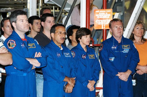 KENNEDY SPACE CENTER, FLA. -  While STS-114 Commander Eileen Collins talks to workers in the Orbiter Processing Facility, standing by are (left to right) astronaut Stephen Frick and Mission Specialists Charles Camarda, Wendy Lawrence and Andy Thomas.  Frick is a tile specialist who joined the STS-11