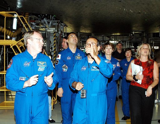 KENNEDY SPACE CENTER, FLA. -  The STS-114 mission crew walks through the Orbiter Processing Facility looking at the tiles underneath Atlantis.  From left are Mission Specialists Andy Thomas, Stephen Robinson, Soichi Noguchi and Charles Camarda (pointing); Commander Eileen Collins; and Mission Specia