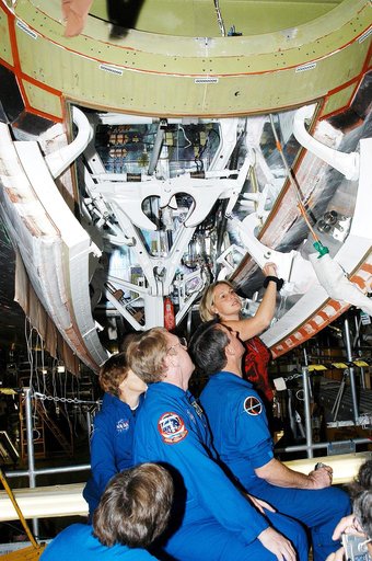 KENNEDY SPACE CENTER, FLA. -  Members of the STS-114 crew look over Shuttle equipment in the Orbiter Processing Facility.  In the foreground is Mission Specialist Wendy Lawrence, who is a new addition to the crew.  Behind her are (left to right) Commander Eileen Collins and Mission Specialists Andy 