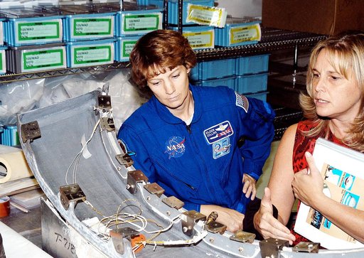 KENNEDY SPACE CENTER, FLA. - STS-114 Mission Commander Eileen Collins looks over flight equipment in the Orbiter Processing Facility, along with Glenda Laws, EVA Task Leader, with United Space Alliance at Johnson Space Center. The STS-114 crew is at KSC to take part in crew equipment and orbiter fam