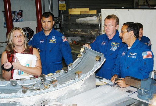 KENNEDY SPACE CENTER, FLA. - Members of the STS-114 crew look over flight  equipment in the Orbiter Processing Facility.  From left are Glenda Laws, EVA Task Leader, with United Space Alliance at Johnson Space Center, Mission Specialists Soichi Noguchi, Andy Thomas, Charles Camarda and Wendy Lawrenc