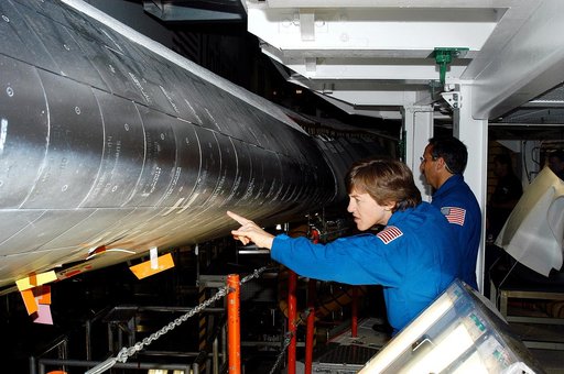 KENNEDY SPACE CENTER, FLA. -   In the Orbiter Processing Facility, STS-114 crew members look at the tiles on the wing of Atlantis. In the foreground is Mission Specialist Wendy Lawrence, who is a new addition to the mission crew.  Behind her is Mission Specialist Charles Camarda, also a new addition
