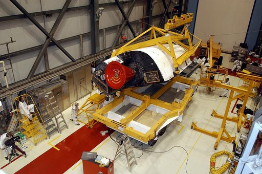 KENNEDY SPACE CENTER, FLA. - In the Orbiter Processing Facility, one of two orbital maneuvering system (OMS) pods is being moved for installation on Atlantis.  The OMS pods are attached to the upper aft fuselage left and right sides. Fabricated primarily of graphite epoxy composite and aluminum, eac