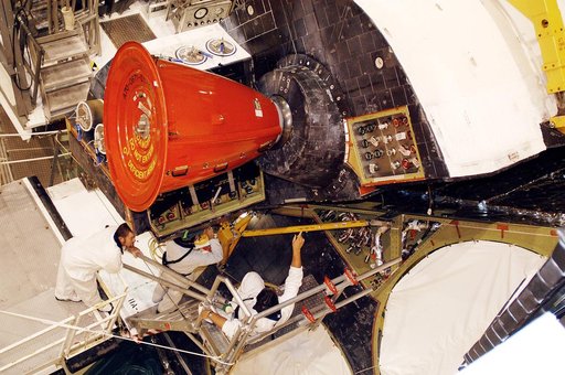 KENNEDY SPACE CENTER, FLA. -  In the Orbiter Processing Facility, technicians move an orbital maneuvering system (OMS) pod into the correct position on Atlantis. The OMS pod is one of two that are attached to the upper aft fuselage left and right sides. Fabricated primarily of graphite epoxy composi