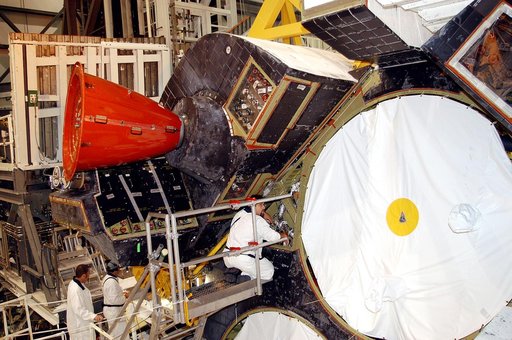 KENNEDY SPACE CENTER, FLA. - In the Orbiter Processing Facility, technicians make adjustments to the orbital maneuvering system (OMS) pod being installed on Atlantis.   The OMS pod is one of two that are attached to the upper aft fuselage left and right sides. Fabricated primarily of graphite epoxy 